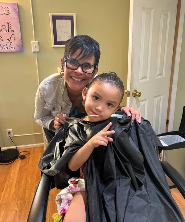 A family leaving a My Hair Helpers salon smiling after lice treatment